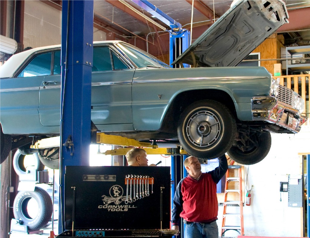 Mechanic working on brake repair Desborough, Northamptonshire